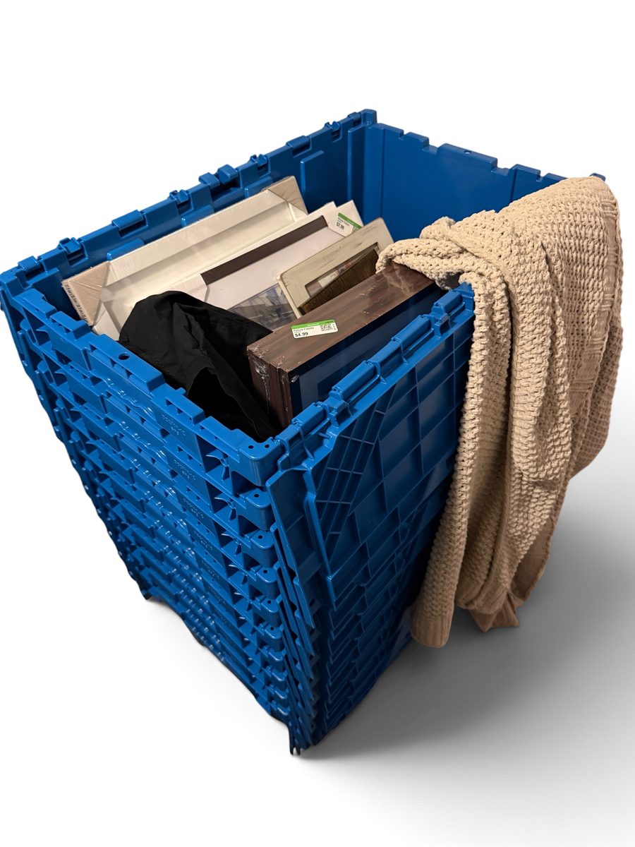 Berkeley Storage tote packed with picture frames, folded clothing, and a throw blanket